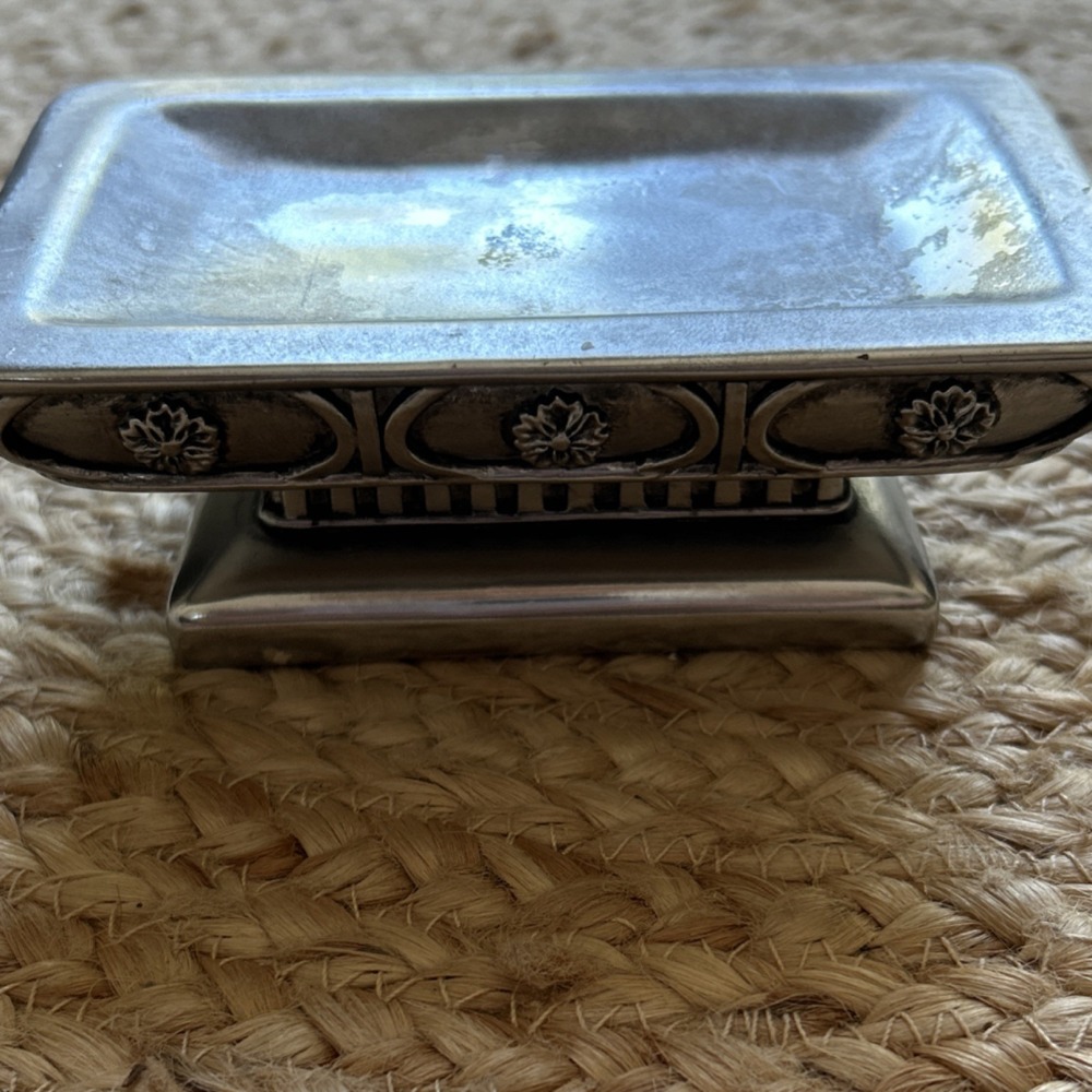 decorative silver-tone pedestal dish, likely used as a soap dish, trinket holder